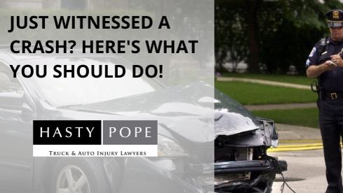 Post car crash a police officer taking notes of scene